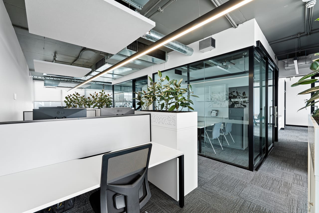 Commercial office fit-out with a continuous linear LED batten running the length of the ceiling