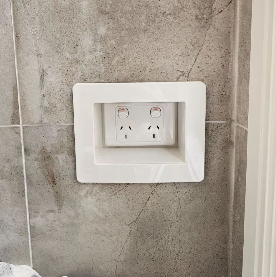 A double power point set flush and square into a large format tiled wall